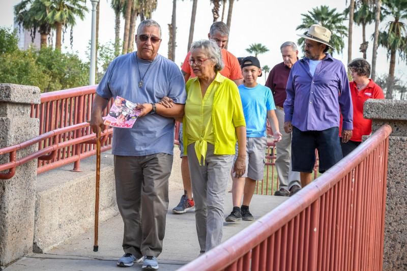 Adults and kids walking on an accessible path.