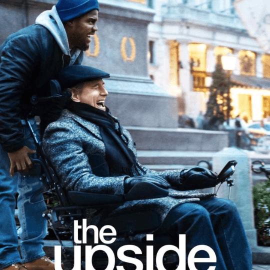 Man in a wheelchair smiling as he is getting pushed by another man that is smiling